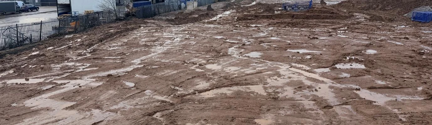 Muddy construction working area with surface water